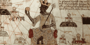 Mansa Musa, emperador del reino de Mali en el siglo XIV, representado en el Atlas catalán (1375), sosteniendo una pepita de oro: símbolo del papel central del comercio aurífero subsahariano en las redes económicas que Ibn Jaldún integró en su lectura global del Magreb medieval.
