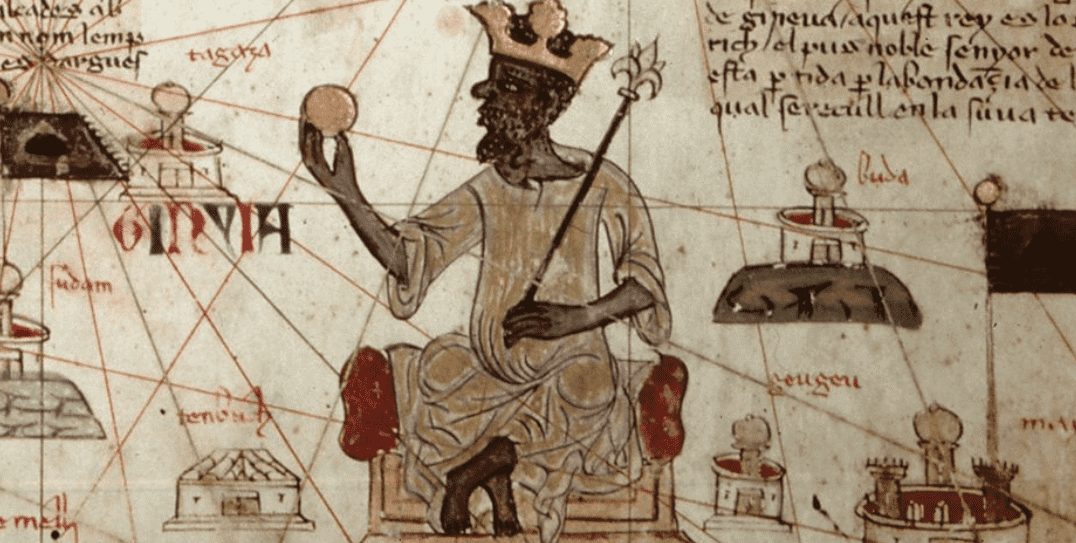 Mansa Musa, emperador del reino de Mali en el siglo XIV, representado en el Atlas catalán (1375), sosteniendo una pepita de oro: símbolo del papel central del comercio aurífero subsahariano en las redes económicas que Ibn Jaldún integró en su lectura global del Magreb medieval.